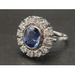 An 18 K white gold ring with a central tanzanite, surrounded by a dozen brilliant cut diamonds. Ring