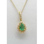 A GOOD SIZE PEAR SHAPED EMERALD SURROUNDED BY BRIGHT DIAMONDS SET AS A PENDANT IN 18K GOLD ON A