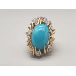 A multi-clawed 18 K yellow gold ring with a large Persian turquoise cabochon surrounded by 18