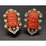 A PAIR OF CORAL AND DIAMOND EARRINGS WITH BUDDHIST GODDESS FACE ON YELLOW METAL. 18.3gmsD