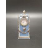 A RUSSIAN GUILLOCHE ENAMEL AND SOLID SILVER MINATURE CLOCK DECORATED WITH DIAMONDS AND RUBY IN THE