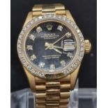 AN 18K GOLD LADIES ROLEX OYSTER PERPETUAL DATEJUST WITH BLACK FACE AND ORIGINAL DIAMOND FACTORY