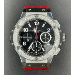 Hublot Big Bang chronometer watch with black face and original diamond dial, red rubber band.