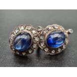 An antique, white on yellow gold pair of earrings with a large Ceylon, royal blue sapphire