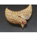 An 18 K yellow gold brooch in the shape of a swallow with diamonds, citrine and ruby. Dimensions: