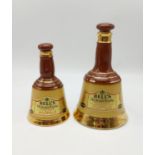 A PAIR OFVINTAGE WADE BELLS OLD SCOTCH WHISKY DECANTERS. TALLEST 20CM IN HEIGHT.