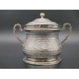 An antique Persian solid silver sugar bowl with lid and two handles with Islamic calligraphy on