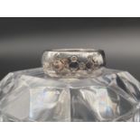 An 18K White Gold and Diamond Band Ring. 0.25ct Size N. 11.35g