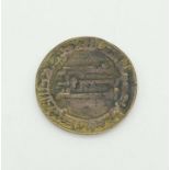 An Early Islamic Bronze Medal with Arabic Calligraphy. 6.5cm diameter.