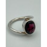 SILVER and AMETHYST RING having large oval stone set to top of modernist design Silver Band.