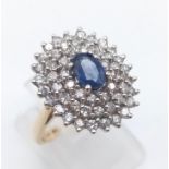 A 14 K yellow gold ring with a central sapphire surrounded by diamonds ( 0.6 carats). Ring size M,