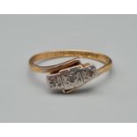 An 18k Yellow Gold Platinum and Diamond Ring. Three small diamonds on a platinum setting. Size L.