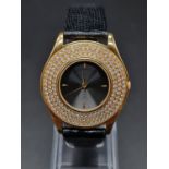 A MAUBOUSSIN I8K GOLD DRESS WATCH WITH 3 ROWS OF DIAMONDS ON THE BEZEL AND SKELETON BACK . 34mm