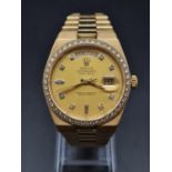 A ROLEX OYSTER PERPETUAL DAY-DATE IN 18K GOLD WITH DIAMOND BEZEL AND NUMERALS. 152gms 36mm