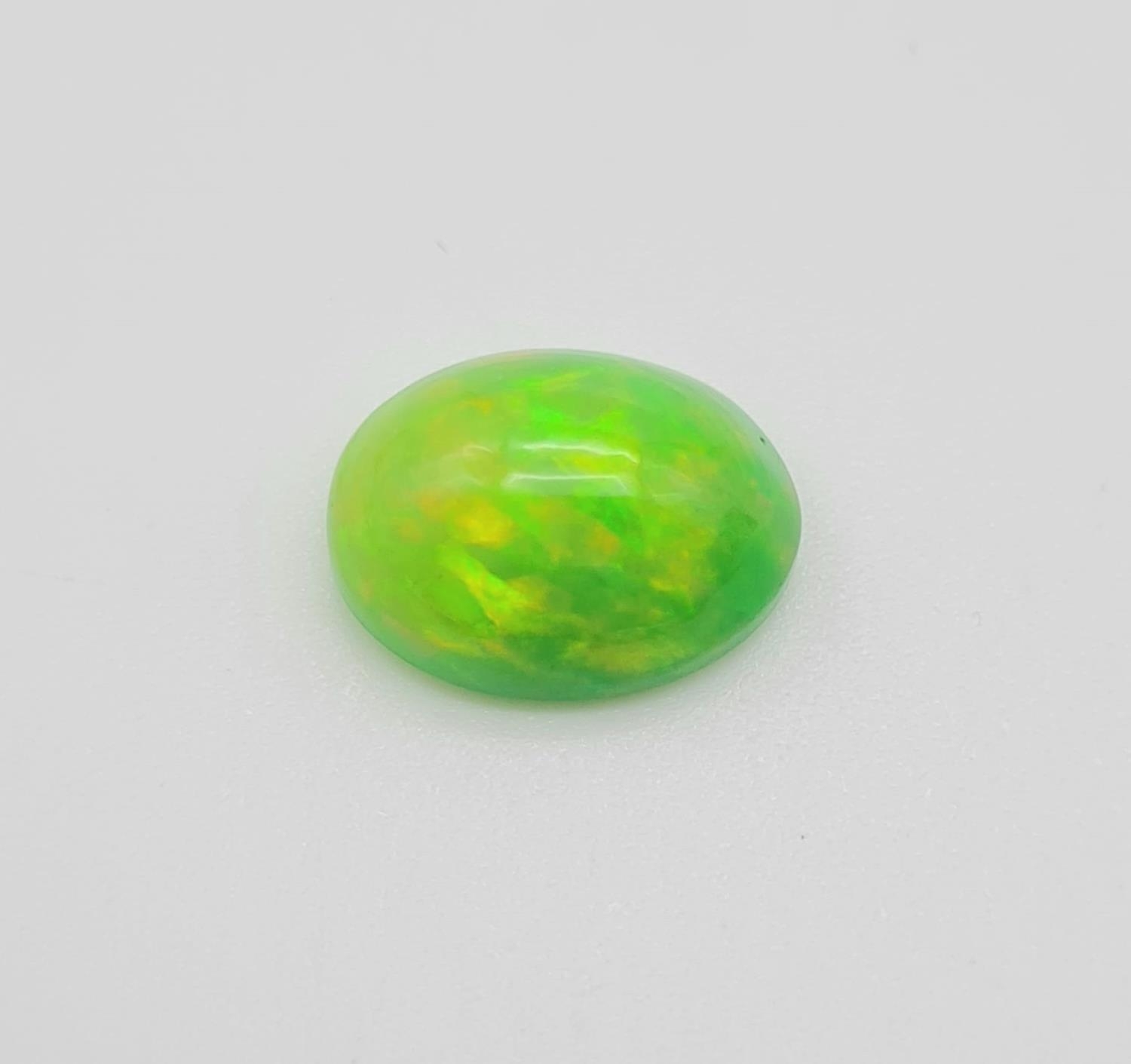 A 4.18ct Natural Green Fire Opal Gemstone in Oval Cabochon. Come with IGL&I Certificate