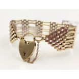 A 9K Yellow Gold Ladder-Link Bracelet with a Heart Charm/Clasp. 16cm. 35g