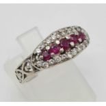 A 9K White Gold Diamond and Pink Sapphire Ring. Five pink sapphires surrounded by 20 small diamonds.