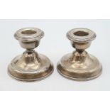 A PAIR OF SIVER CANDLE HOLDERS. 254gms 6.5cms height