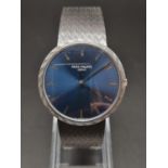 A PATEK PHILIPPE IN 18K WHITE GOLD WITH CIRCULAR BLUE FACE MANUAL MOVEMENT. 35mm