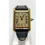 A CARTIER LADIES GOLD PLATED TANK STYLE WATCH WITH LEATHER STRAP AND ROMAN NUMERALS 20mm