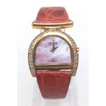 AN UNUSUAL HORSESHOE SHAPED 18K GOLD AND DIAMOND DRESS WATCH BY SARCAR OF GENEVA ON RED CROCODILE