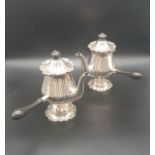 A PAIR OF SOLID SILVER CAFE AU LAIT COFFEE POTS MADE BY MARTIN AND HALL OF SHEFFIELD IN 1913.
