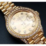 A LADIES 18K GOLD ROLEX OYSTER PERPETUAL DATEJUST WITH DIAMOND BEZEL AND NUMERALS AND GOLDTONE FACE.