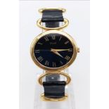 A LADIES 18K GOLD PIAGET WRIST WATCH OVAL SHAPE WITH BLACK FACE MANUAL MOVEMENT 26 X 24mm