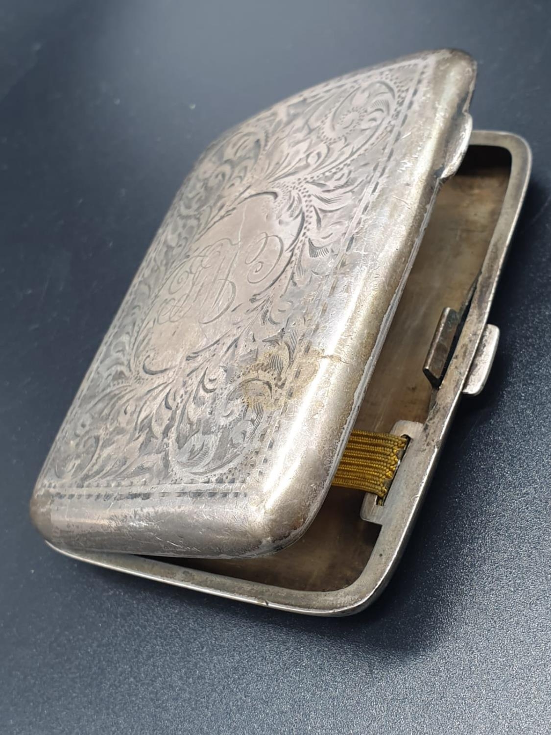 A Birmingham 1919 Hallmarked Silver Cigarette Case. Engraved decoration. A few signs of wear. A/F. - Image 2 of 7