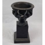 An Antique Bronze Cup or Vase. Decorated with vine-like handles and ornate images of perhaps