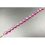 A Gold Plated Pink Jade Bracelet. 18cm. Beautiful pink jade cabochons.