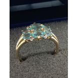 9 carat GOLD CLUSTER RING having blue Topaz coloured stones set to top. Attractive gold openwork