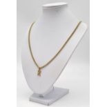 A 9k Yellow Gold Letter K Pendant. 1.51g. Comes with a long yellow metal chain necklace. 66cm