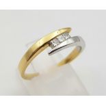 An 18K Two-Tone Three Diamond Twist Ring. Size Q. 0.30ct. 3.7g