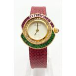 A BOUQUET LADIES WATCH WITH CHANNEL SET RUBYS AND EMERALDS AND A DIAMOND BEZEL IN 18K GOLD. 30mm