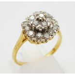 An 18K Yellow Gold Diamond Cluster Ring. Floral shape - 1.0ct. H-VS Grade. Size P. 3.7g.