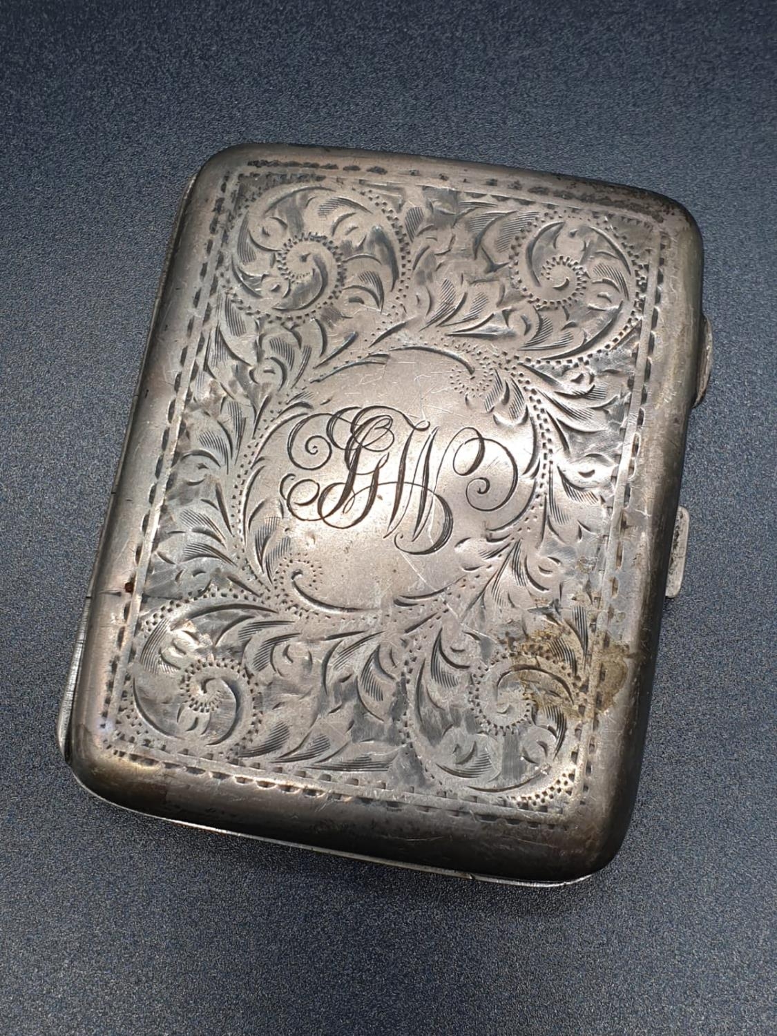 A Birmingham 1919 Hallmarked Silver Cigarette Case. Engraved decoration. A few signs of wear. A/F.