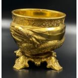 A large, heavy brass bowl with an ornate dragon and base with four feet. Height: 14.5 cm,