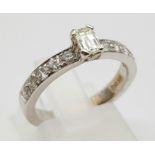 An 18K White Gold Diamond Ring. Central stone with diamonds on shoulders. 0.75ct. H-VVS Grade.