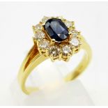 An 18K Yellow Gold Sapphire and Diamond Ring. Central sapphire -0.90ct, surrounded by a halo of