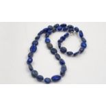 A Natural Lapis Lazuli and Silver Clasp Necklace. Different shaped beads make this necklace truly