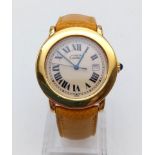 A LADIES CARTIER CIRCULAR GOLD PLATED SILVER WATCH WITH ROMAN NUMERALS ON THE ORIGINAL CARTIER