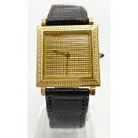 A BOUCHERON 18K GOLD SQUARE WATCH WITH PATTERNED FACE. 25mm