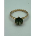 9 carat GOLD RING having large green quartz solitaire set to top in a cathedral mount.