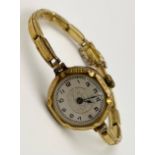 A Vintage Possibly Antique 18K Yellow Gold Ladies Watch. In working order. Gold strap and Case -