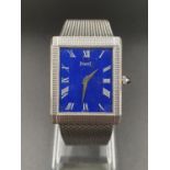 A LADIES 18K WHITE GOLD WRIST WATCH BY PIAGET WITH A RARE BLUE FACE IN SQUARE TANK STYLE. 26 X 23mm