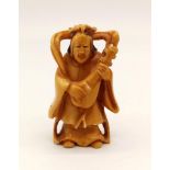 A 19th Century, Japanese, carved ivory netsuke of a musician. Height: 5.2 cm, weight: 25 g.