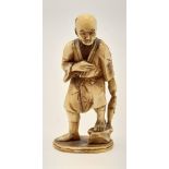 A 19th century carved ivory Japanese Okimono figure of a fisherman (signed). Height: 8 cm, weight:
