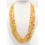 A three strand necklace with hand carved citrine beads. Length: 50-63 cm, weight: 78 g.