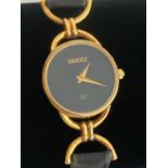 Ladies Quartz wristwatch having black face with marking showing Gucci. Watch case showing serial